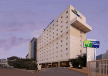 a large hotel with a lot of windows and a sign that says holiday inn express on it .