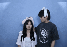 a girl wearing bunny ears stands next to a boy wearing a t-shirt that says jesus