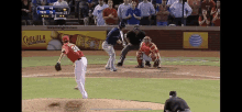 a baseball game is being played in front of an ad for cholula beer