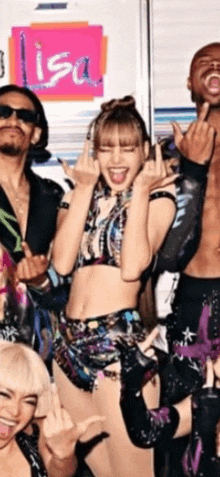 a group of people are posing for a picture and one of them is wearing a crop top .