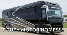 a large black rv with the words " f they motor homes " on it