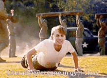 a man is doing push ups in a field while a group of people carry a wooden bar over his head .