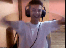 a man wearing headphones and a white shirt is dancing in a video call