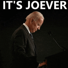 joe biden giving a speech with the words it 's joever behind him