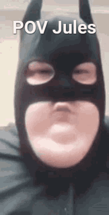 a close up of a person wearing a batman mask with the words `` pov jules '' written on it .