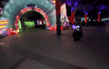 a blurred image of a park with a sign that says ' plaza ' on it