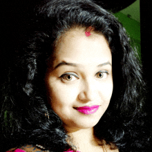 a close up of a woman 's face with dark hair and pink lipstick