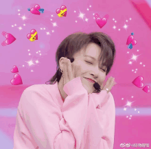 a woman in a pink sweater is surrounded by pink hearts and stars