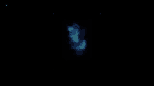 a blue glowing object is floating in the dark