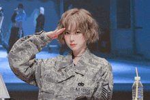 a woman in a us air force uniform saluting