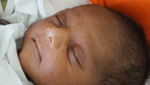 a close up of a newborn baby sleeping