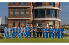 a group of nurses pose for a picture in front of a building that has the word river on it