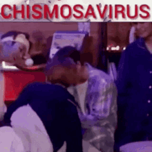 two men are kissing in front of a sign that says chismosavirus