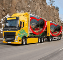 a volvo truck is driving down the road