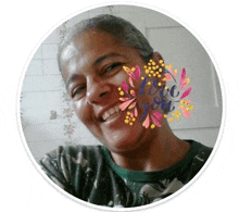 a woman is smiling in a circle with a flower on her face .