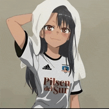 a girl with a towel on her head is wearing a pilsen del sur jersey