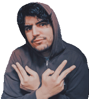 a man in a hoodie is making a peace sign with his fingers