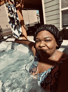 a woman wearing a bathing cap is standing in a hot tub