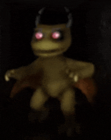 a blurred image of a frog with horns and red eyes .