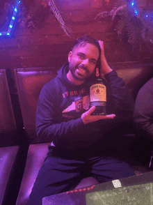 a man is holding a bottle of jameson irish whiskey