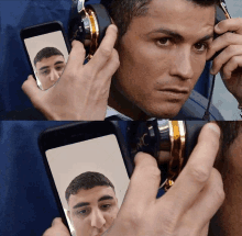 a man wearing headphones takes a picture of himself on a cell phone