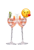 two cascara wine glasses with a kissing emoji on top of them