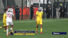 a soccer game between cavad karimov and ganca with a troll face on the player 's jersey