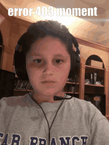 a young boy wearing headphones and a shirt that says car france