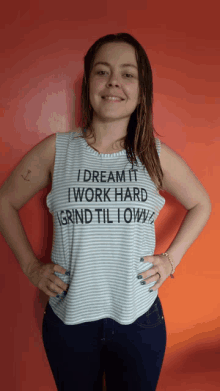 a woman wearing a shirt that says i dream it i work hard grind til i own it