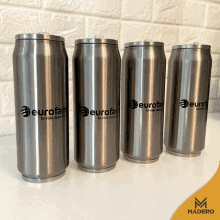 four stainless steel cans with the words eurofam on them