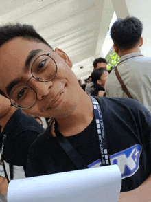 a man wearing glasses and a lanyard that says ' political science '