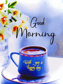 a blue cup of coffee with the words good morning wish you a happy day on it