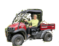 a woman is sitting in a red kawasaki 4x4