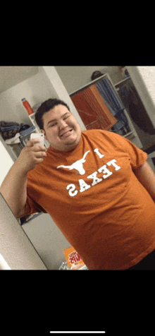 a man wearing an orange texas longhorn shirt