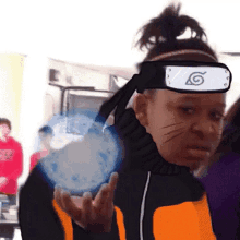 a person wearing a headband with a naruto symbol on it