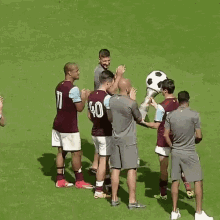 a group of soccer players are standing on a field and one of them has the number 40 on his back