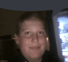 a boy is smiling in front of a vending machine that says ' imgflip.com ' on it