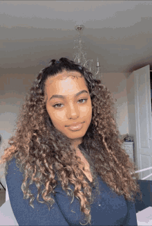 a woman with curly hair wearing a black shirt