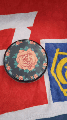 a plate with a rose on it sits on a towel