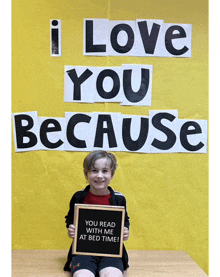 a young boy is holding a sign that says you read with me at bed time