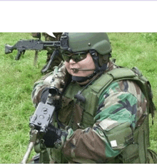 a man in a military uniform is holding a gun