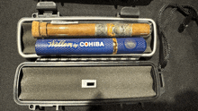 two cigars in a case which says wellen by cohiba