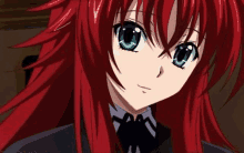 a girl with red hair and blue eyes is wearing a black jacket and tie .