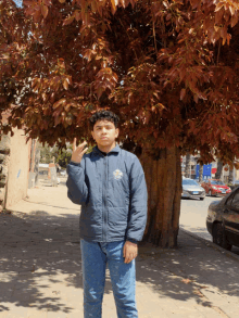 a boy wearing a blue jacket with the word california on the front