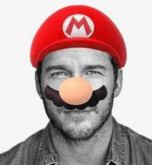 a man with a beard and mustache is wearing a mario hat and mask .