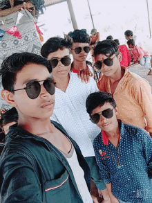 a group of boys wearing sunglasses pose for a photo