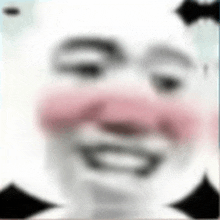 a blurry picture of a person 's face with a pink nose and cheeks .