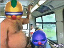 a gif of a man wearing a clown mask riding a bus