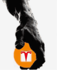 a black and white image of a hand holding an orange tesla logo