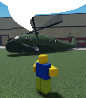 a roblox character stands in front of a green helicopter with a star on the side